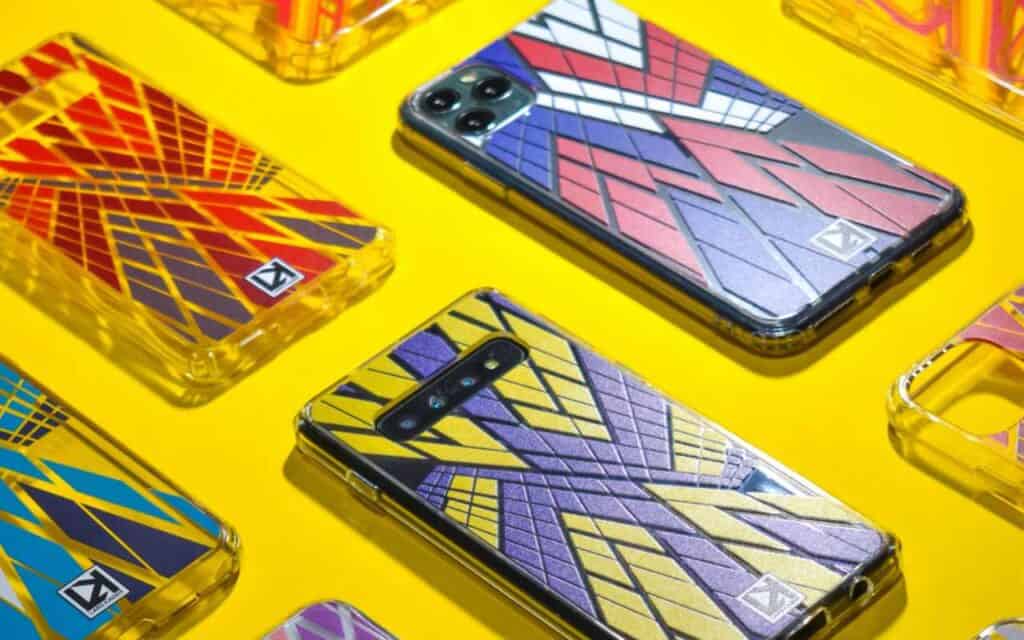 Phone cases in superhero colours are lined up across a yellow background